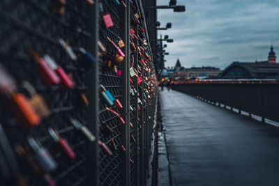 Graffiti on bridge in city against sky at dusk