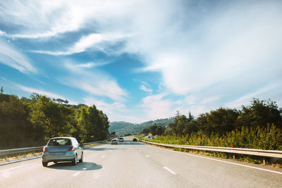 Cars on road against sky