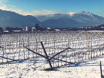Scenic view of snow covered field against sky