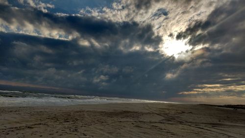 Scenic view of beach against sky during sunset
