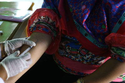 Close-up of woman getting injected by doctor