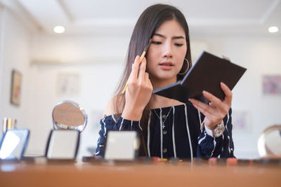 Portrait of young woman using smart phone