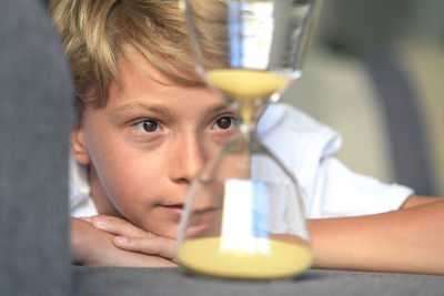Boy looking at hourglass 