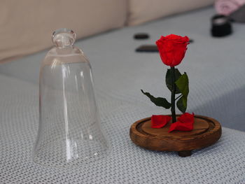 Close-up of red rose on table