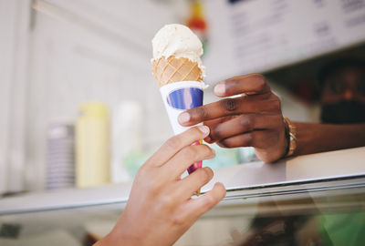 Midsection of woman holding ice cream