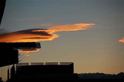 Silhouette city against sky during sunset