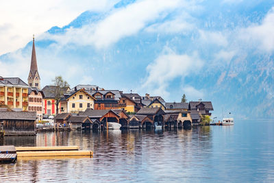 Buildings in city against cloudy sky