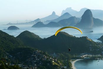 People paragliding over mountains