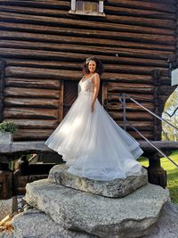 Woman standing on white wall