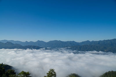 Scenic view of mountains against clear blue sky