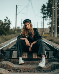 Portrait of young man sitting on steps