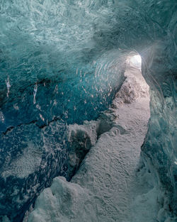 Full frame view through a natural ice tunnel through a glacier