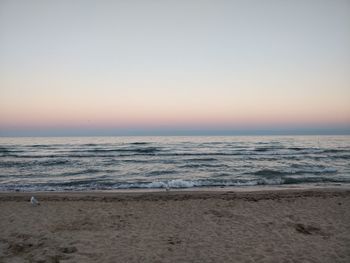 Scenic view of sea against clear sky during sunset