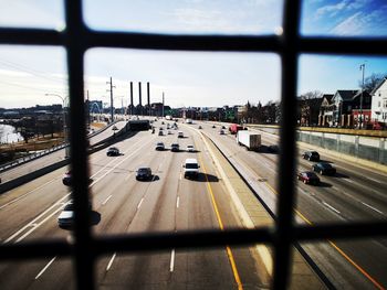 Cars on road in city against sky