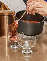 Cropped hand of person preparing food on table