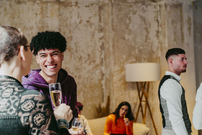 Happy young businessman laughing with colleague during event at convention center