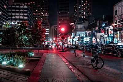 View of city street and buildings at night