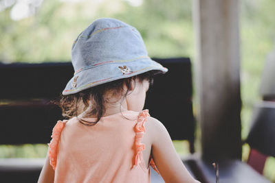 Close-up of girl wearing mask against blurred background