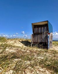 Abandoned building on field against sky