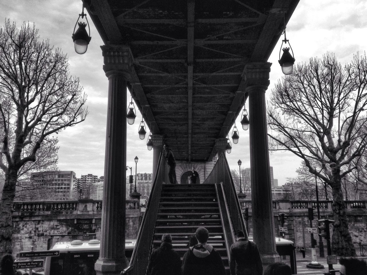 architecture, built structure, bridge - man made structure, connection, sky, tree, building exterior, bare tree, engineering, transportation, low angle view, city, bridge, cloud - sky, travel destinations, travel, famous place, day, architectural column