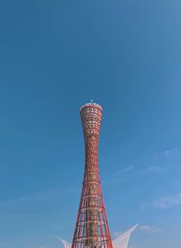 Low angle view of tower against blue sky