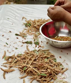 Close-up of hand holding food on table