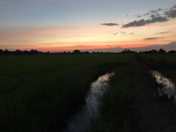 Scenic view of dramatic landscape against sky during sunset