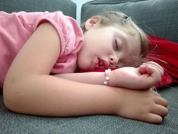 Close-up of girl sleeping on bed