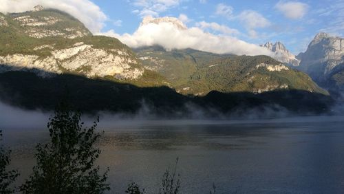 Scenic view of lake and mountains against sky