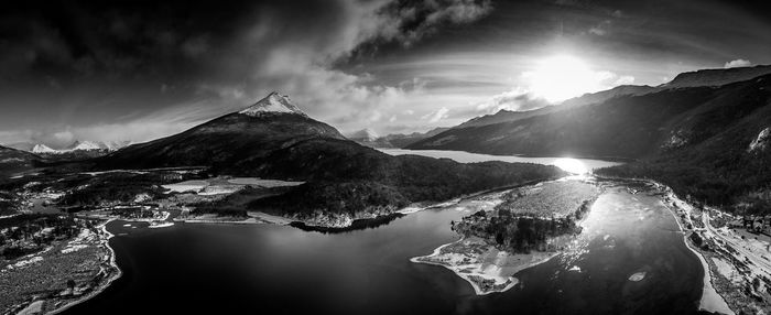 Panoramic view of river by mountains against sky