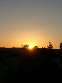 Scenic view of silhouette landscape against clear sky during sunset