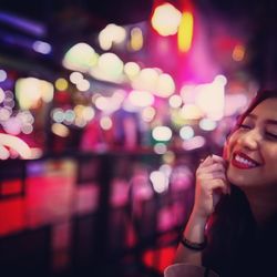 Close-up of smiling woman at nightclub