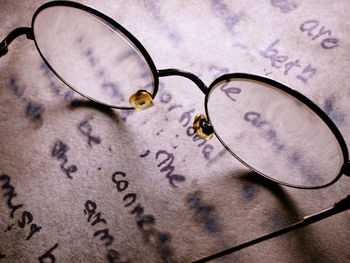 High angle view of eyeglasses on paper