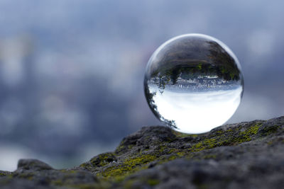 Close-up of crystal ball on rock