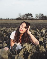 Woman wearing sunglasses on field against sky