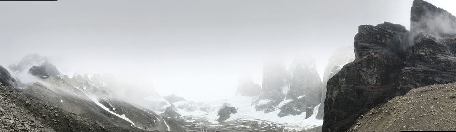 Panoramic view of mountains against sky during winter