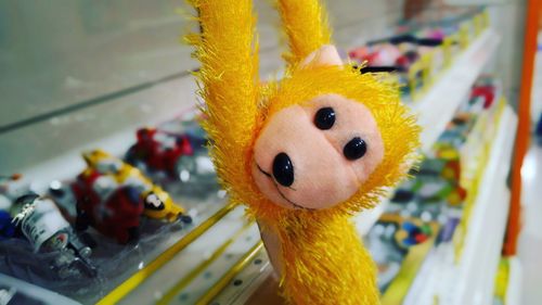 Close-up of yellow monkey toy for sale at store