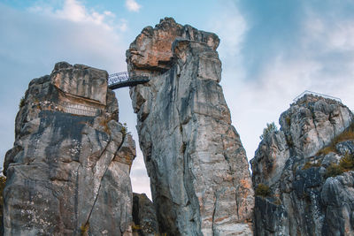 Low angle view of rock formation against sky