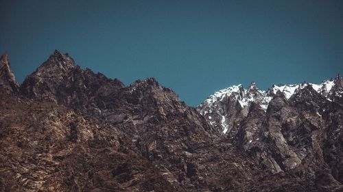 Scenic view of mountains against clear blue sky