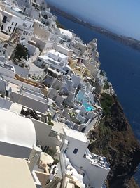 High angle view of town by sea against clear sky