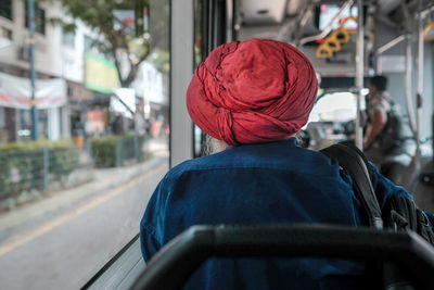 Rear view of man sitting in bus