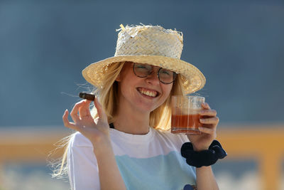 Portrait of a smiling young woman wearing hat