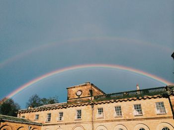 Silhouette of building against cloudy sky