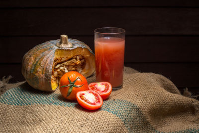 Close-up of orange and juice on table
