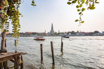 View of boats in canal against sky