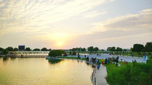 People in river at sunset