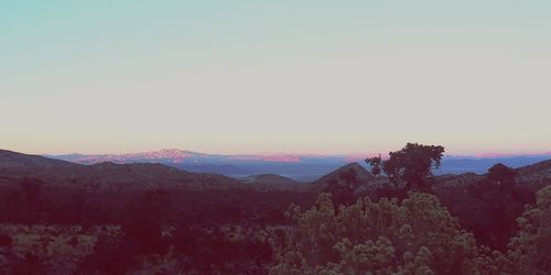 Scenic view of mountains against clear sky during sunset