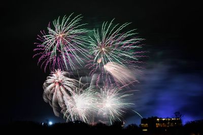 Low angle view of firework display at night