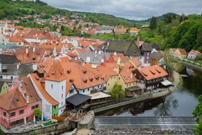 High angle view of houses by river in town