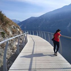 Rear view of woman on mountain against sky